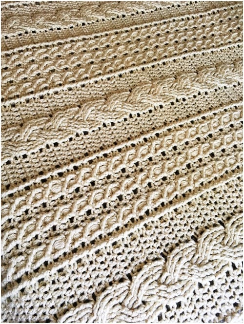 a close up of a white crocheted afghan.