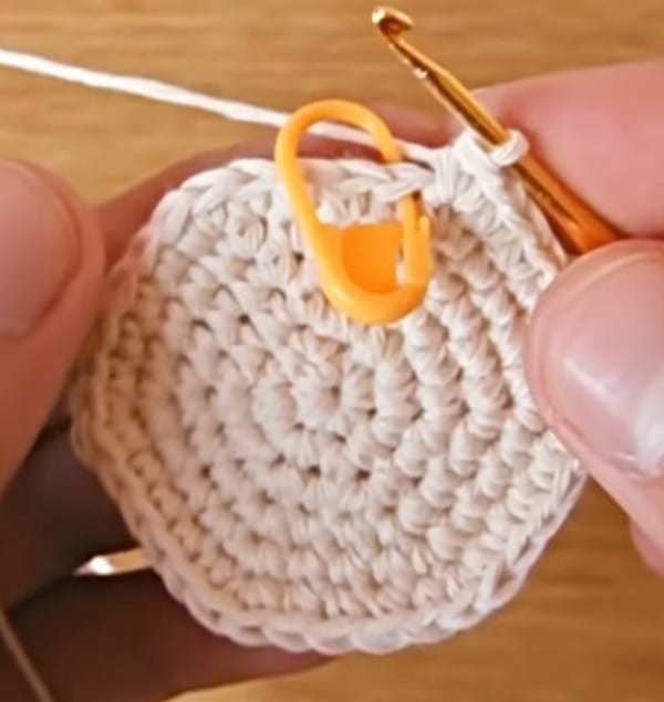 A person is holding a crochet hook and a crochet hook.