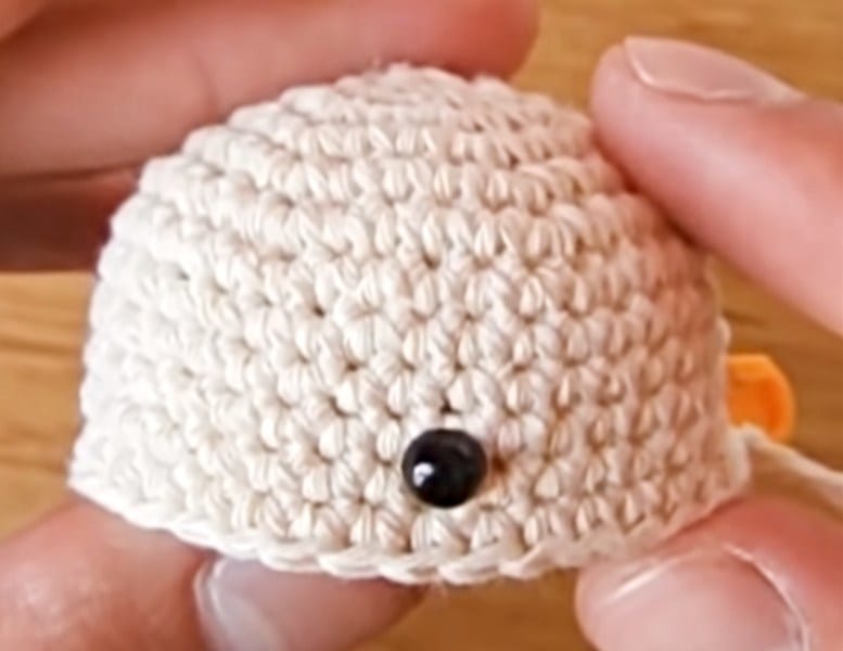 A person holding a knitted object.