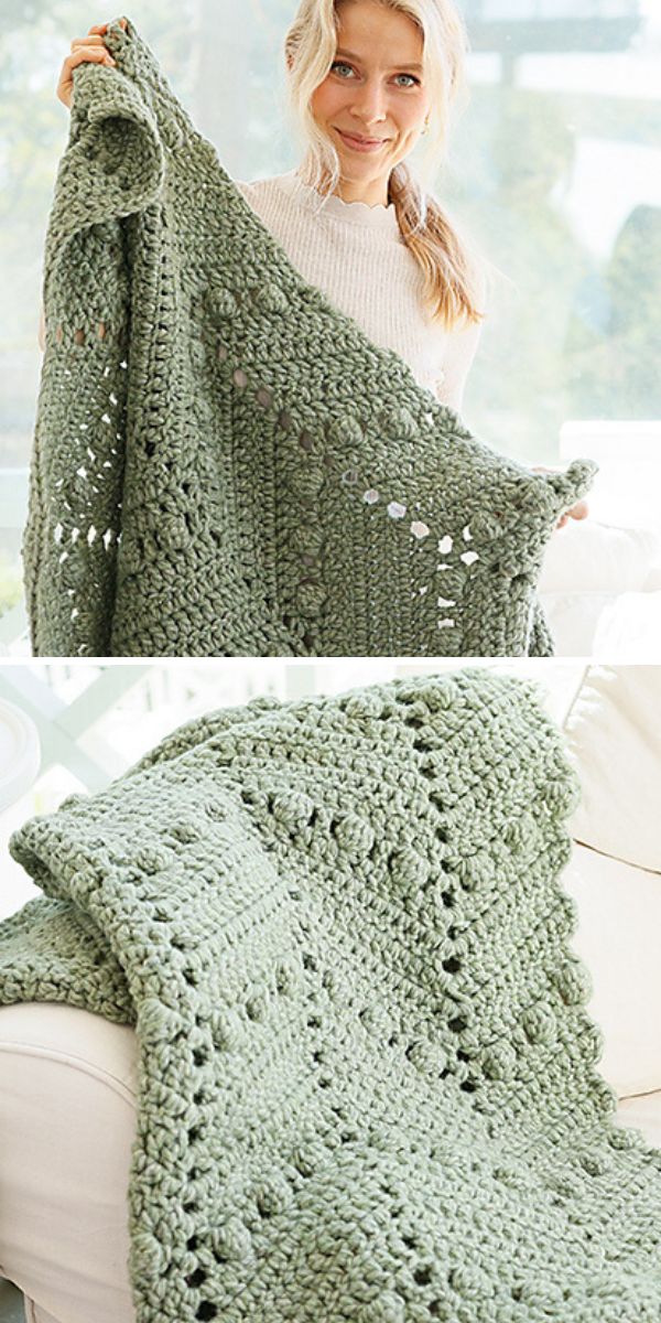 A woman is holding a green crocheted bobble afghan.