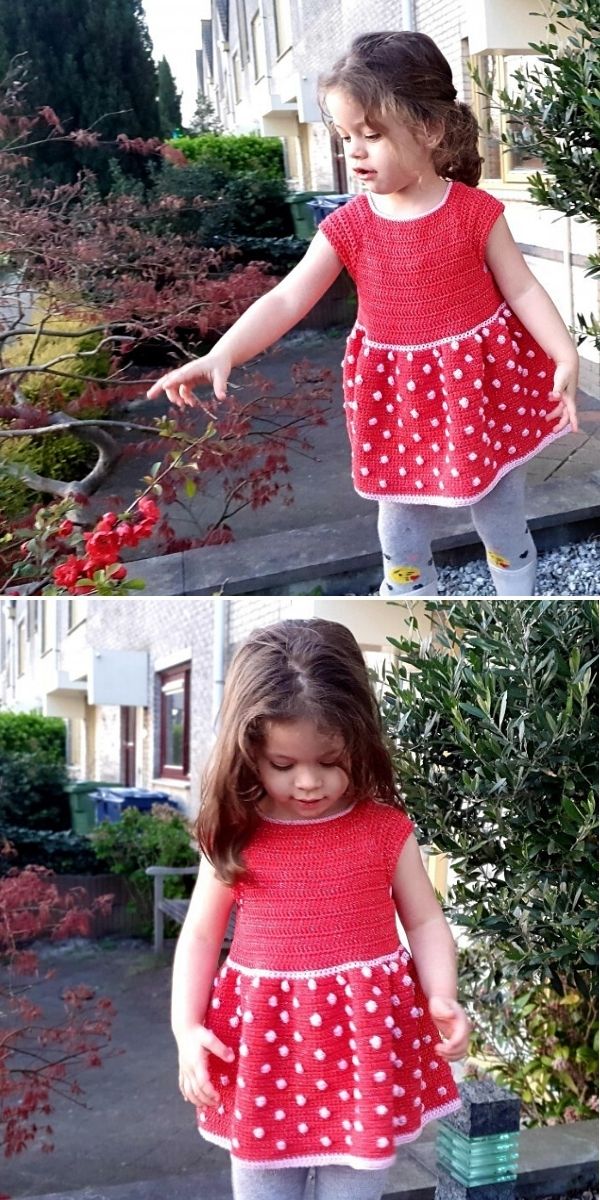 A young girl wearing a red and white polka dot crochet dress stands outside near plants and bushes in a residential area.