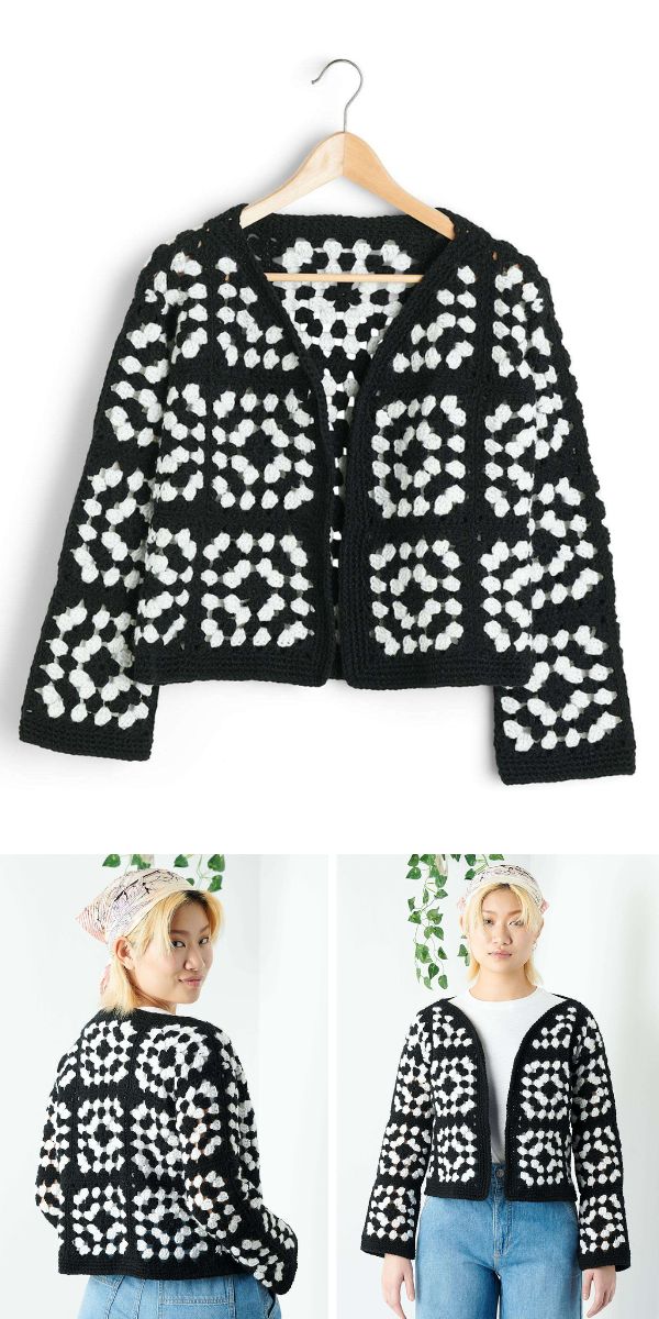 A black and white crocheted granny square cardigan hanging on a hanger.