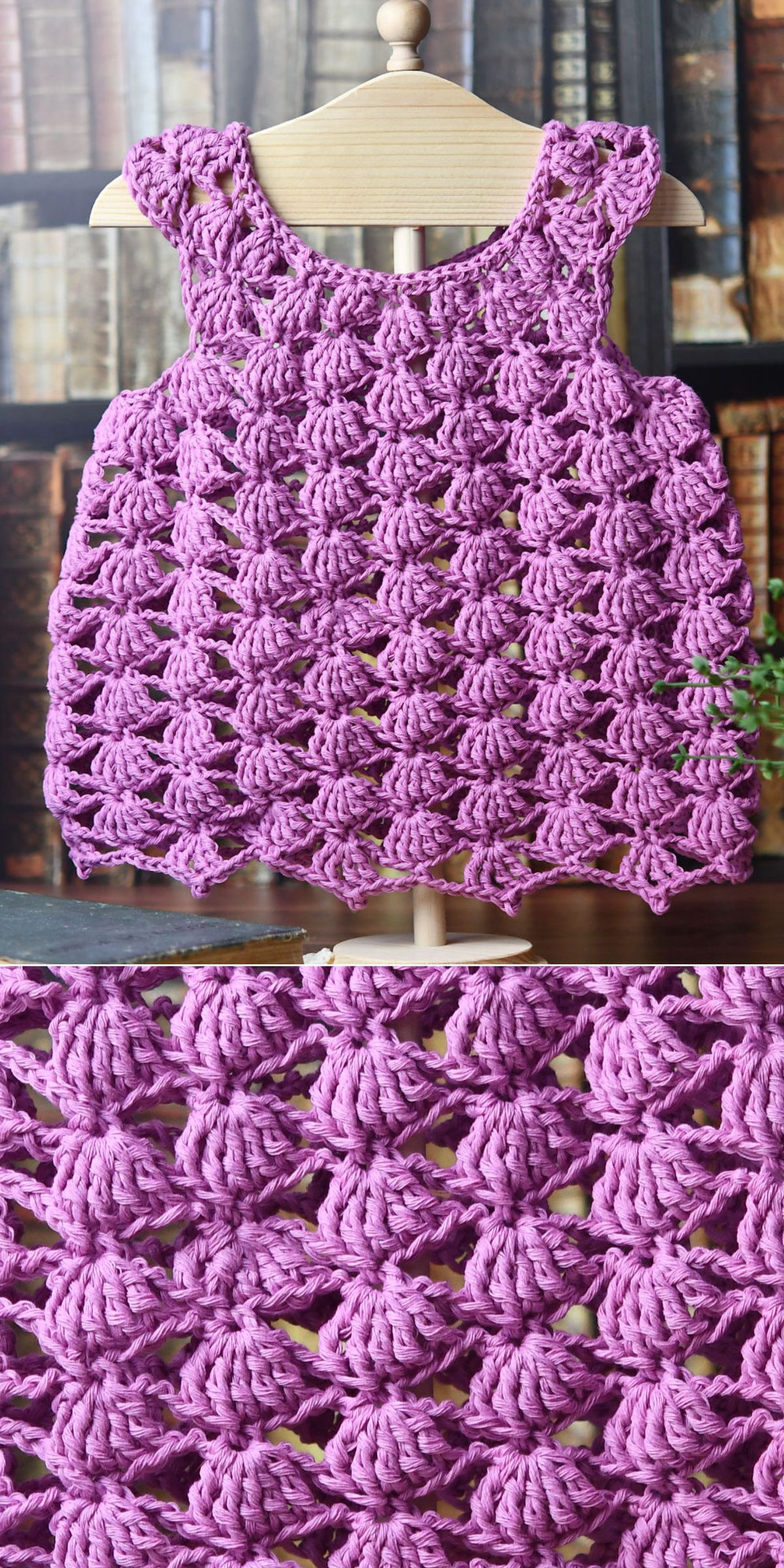 A purple crochet dress for babies, featuring a scalloped, openwork pattern, is displayed on a wooden mannequin with bookshelves in the background.