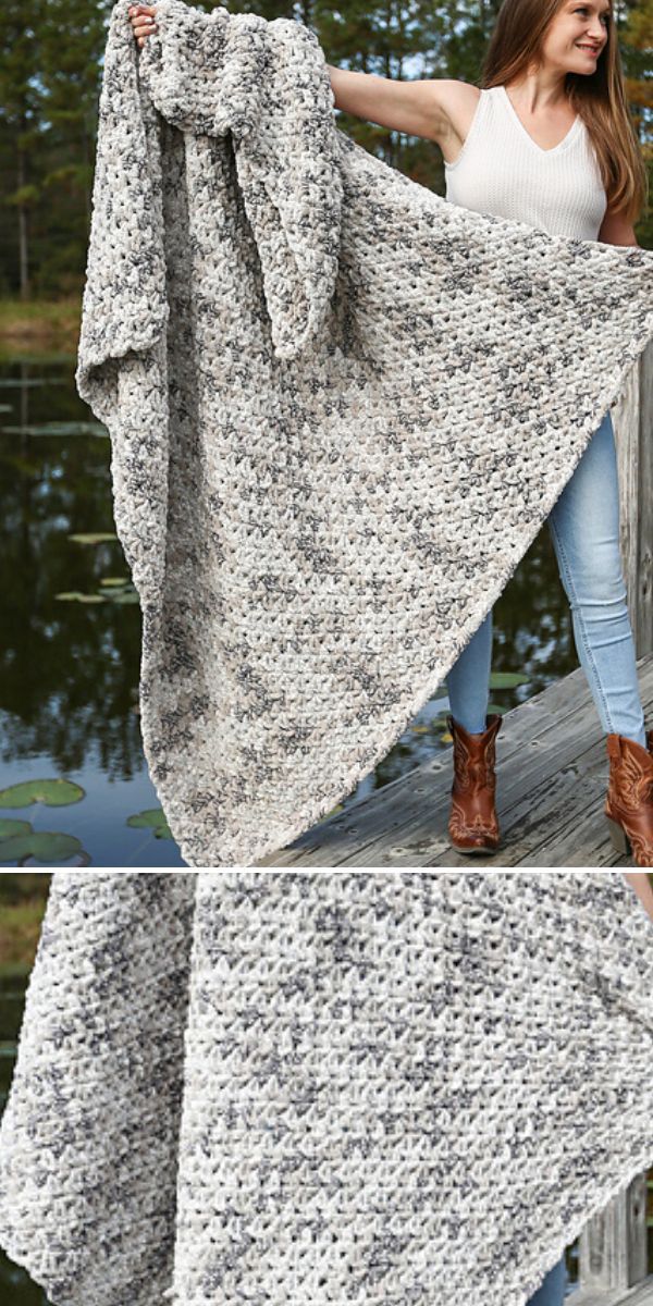 A woman is showcasing a modern crocheted afghan on a dock.