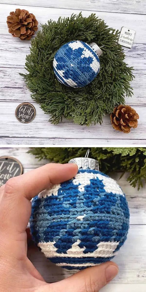 A person is holding a blue and white crochet Christmas bauble.