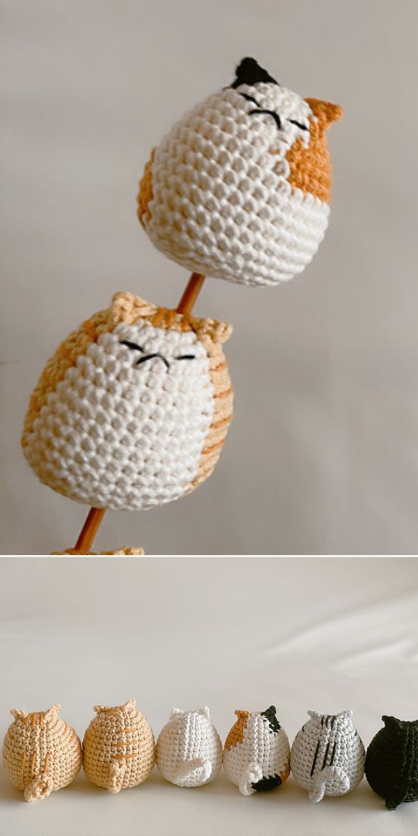 A crochet amigurumi cat sitting on a stick.