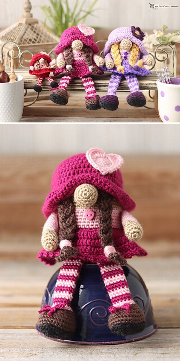 Two amigurumi dolls, crocheted with intricate details, are displayed on a table.