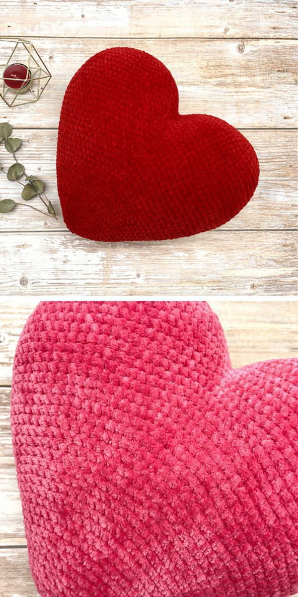 A red heart-shaped crochet pillow on a wooden table perfect for Valentine's Day.