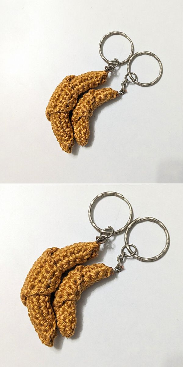 A pair of crochet keychains shaped like bananas.