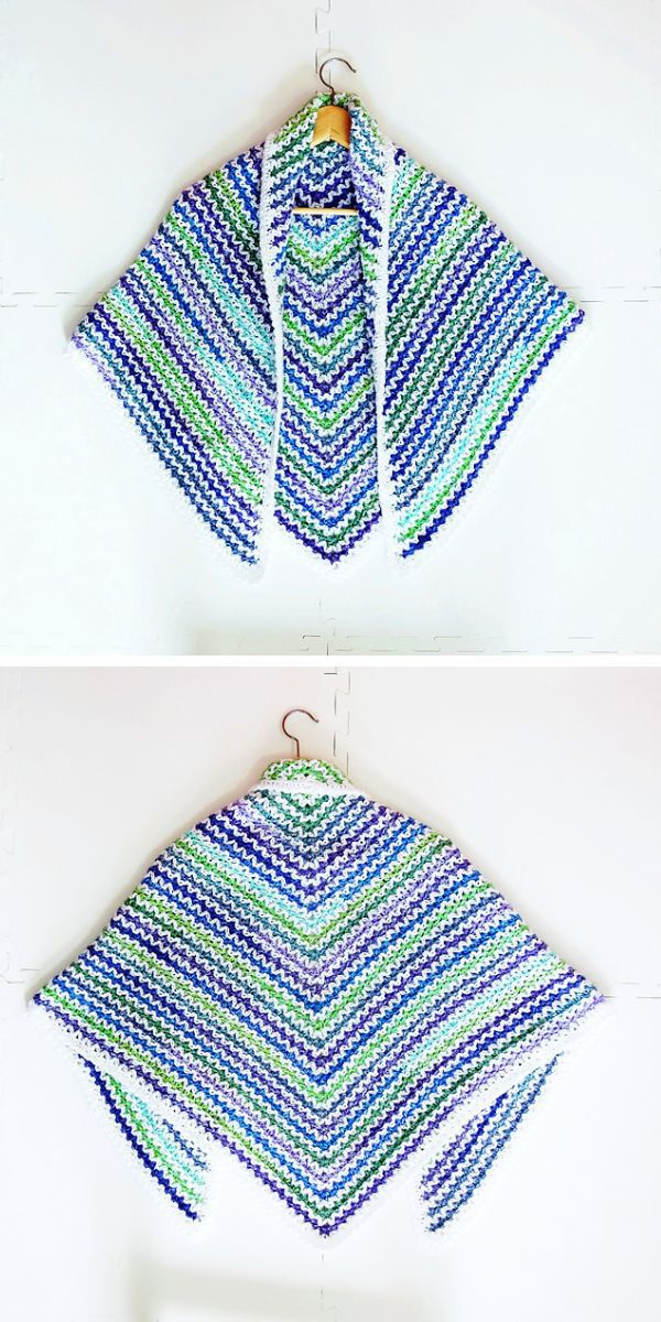 Two crocheted shawls hanging on a hanger.