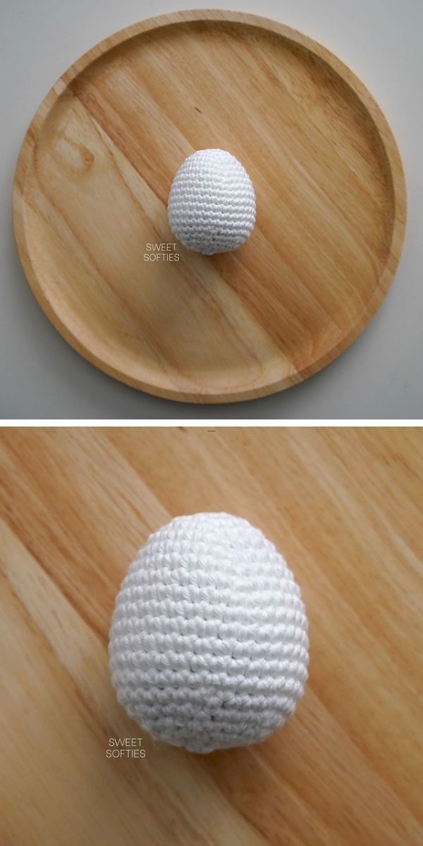 A white crocheted Easter egg on a wooden plate.