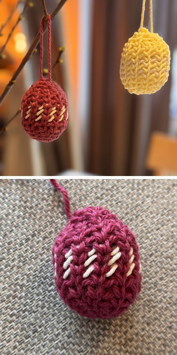 Two handcrafted crochet easter eggs resembling baubles hanging on a display.