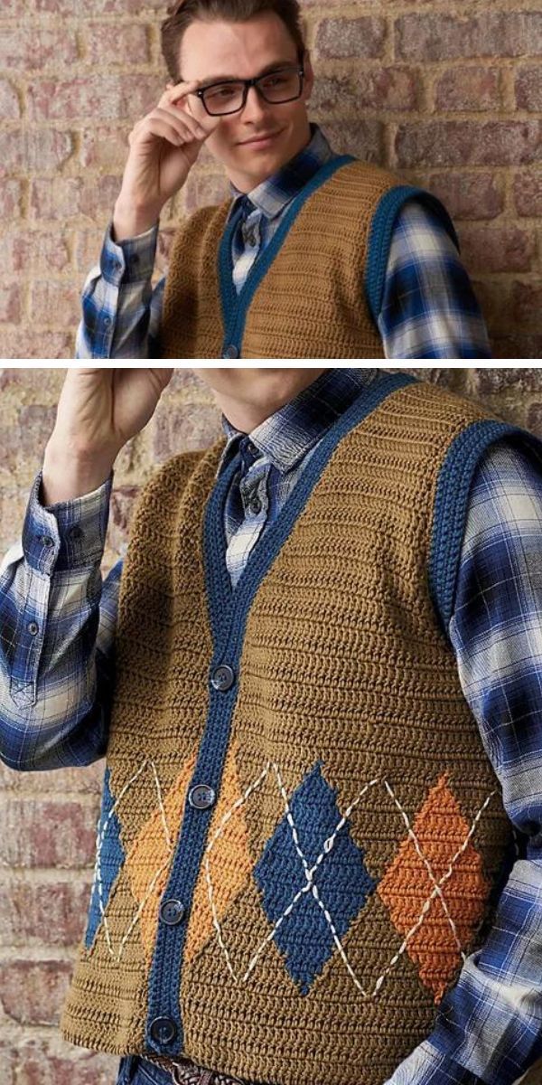 A man in glasses is wearing a blue plaid shirt and a crocheted tan vest with a blue and orange argyle pattern. He is adjusting his glasses with a thoughtful expression.
