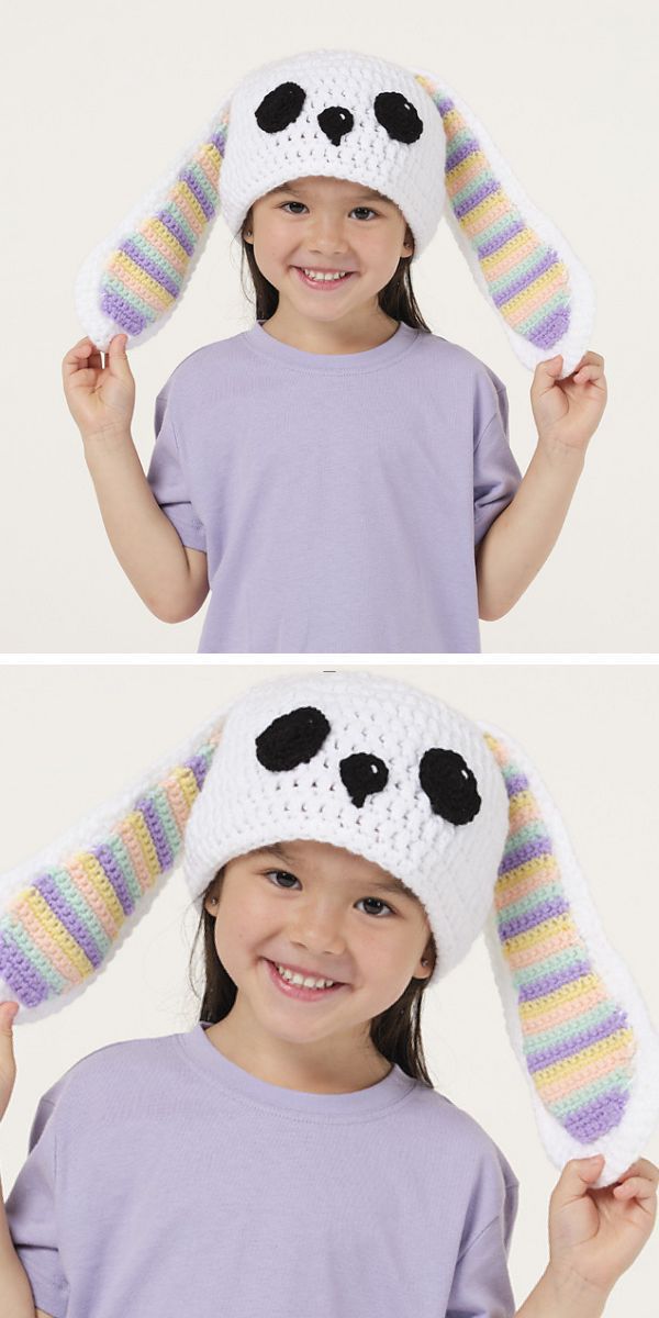 a little girl wearing a white crochet hat with long bunny ears in rainbow colors