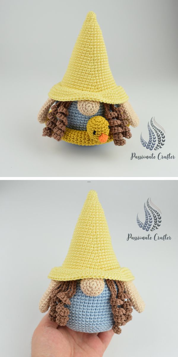 a person holding a crochet female gnome amigurumi with a yellow hat