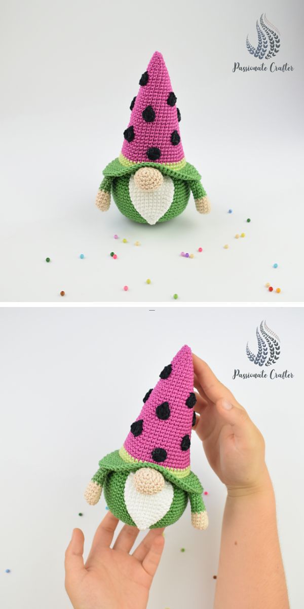 a person holding a green crochet gnome amigurumi with a pink watermelon hat
