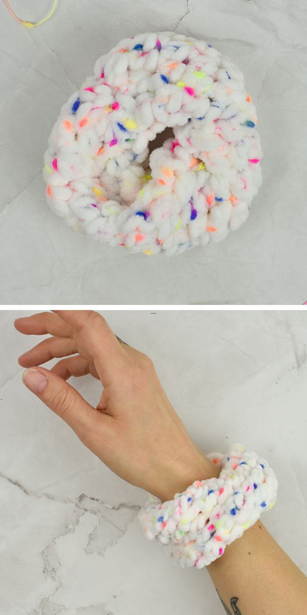 a crochet scrunchie made of chunky yarn with colorful dot prints
