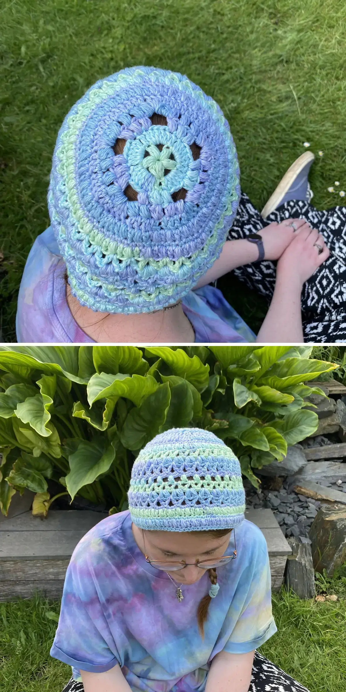 A person wearing a stylish purple and green crochet beanie sits comfortably on the grass, surrounded by lush plants, with hands gently resting on their knees.