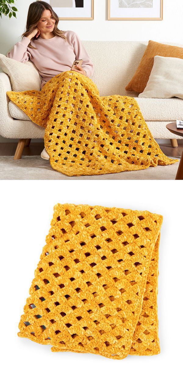 A woman sits on a white sofa, covered with a yellow crochet afghan.
