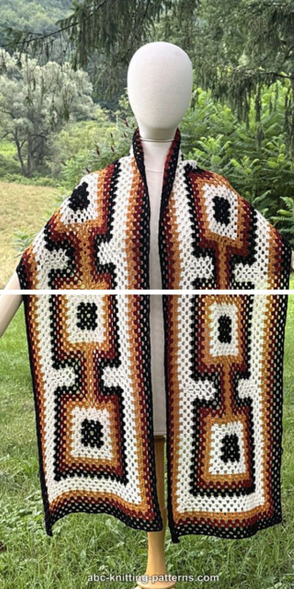 A mannequin displays a colorful crochet wrap scarf with geometric patterns in white, brown, beige, and black.