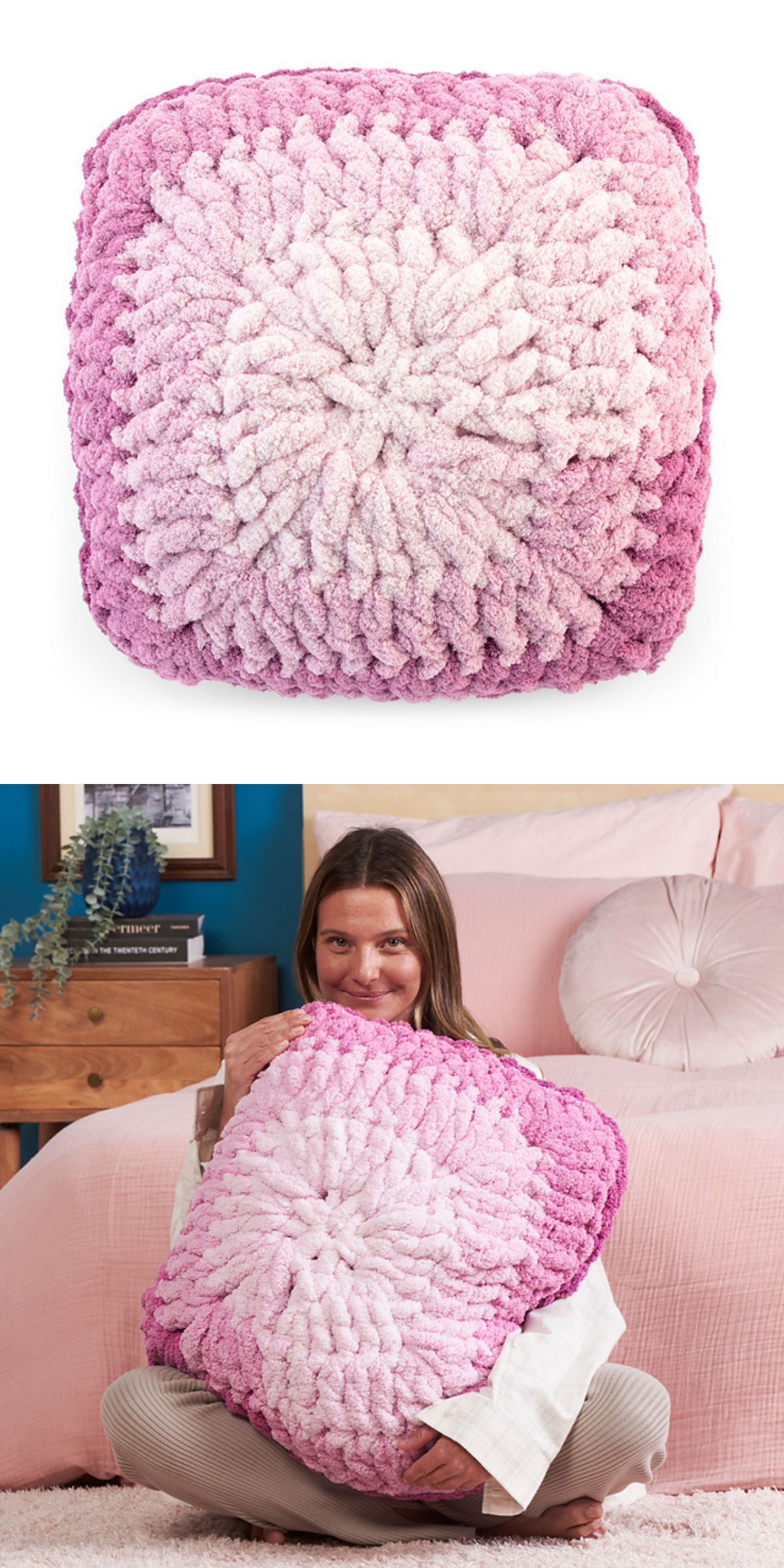 A woman holds a large crochet square pillow with a gradient from light pink to dark pink.
