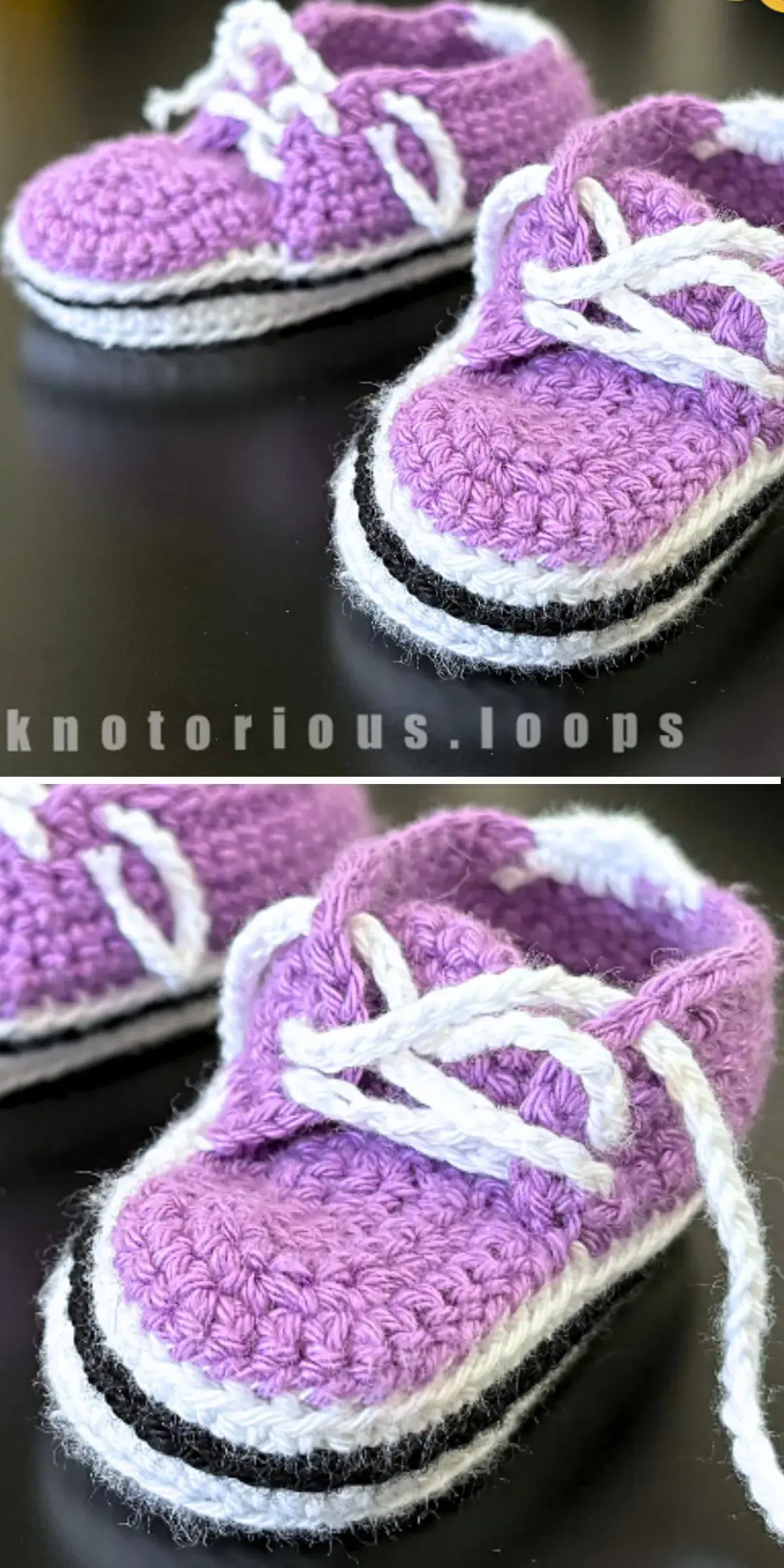 Close-up of purple crochet baby booties with white laces and black soles on a dark surface.