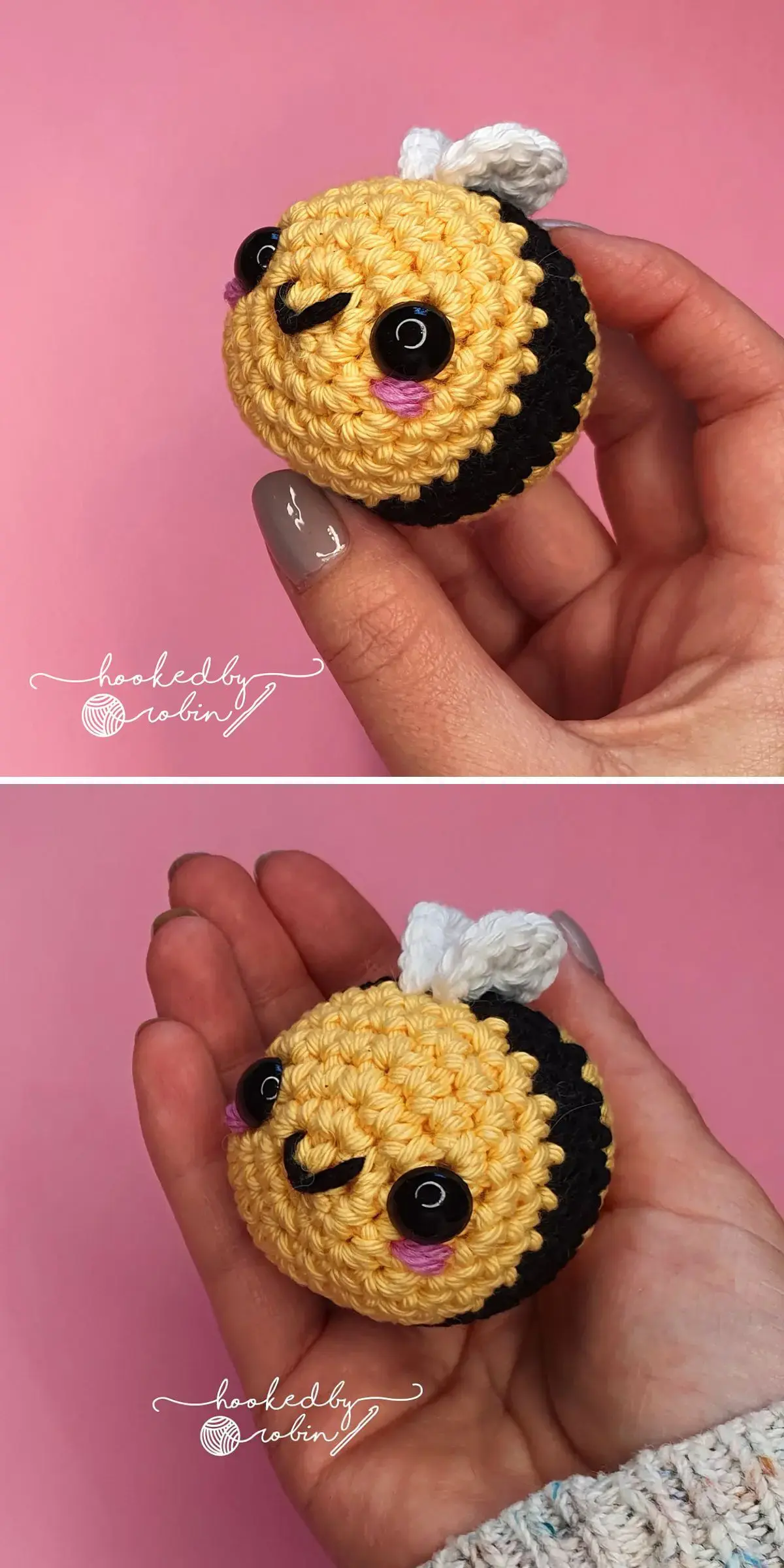 A hand holds an adorable crochet amigurumi bee, sporting a smiley face and delicate white wings, set against a soft pink background.