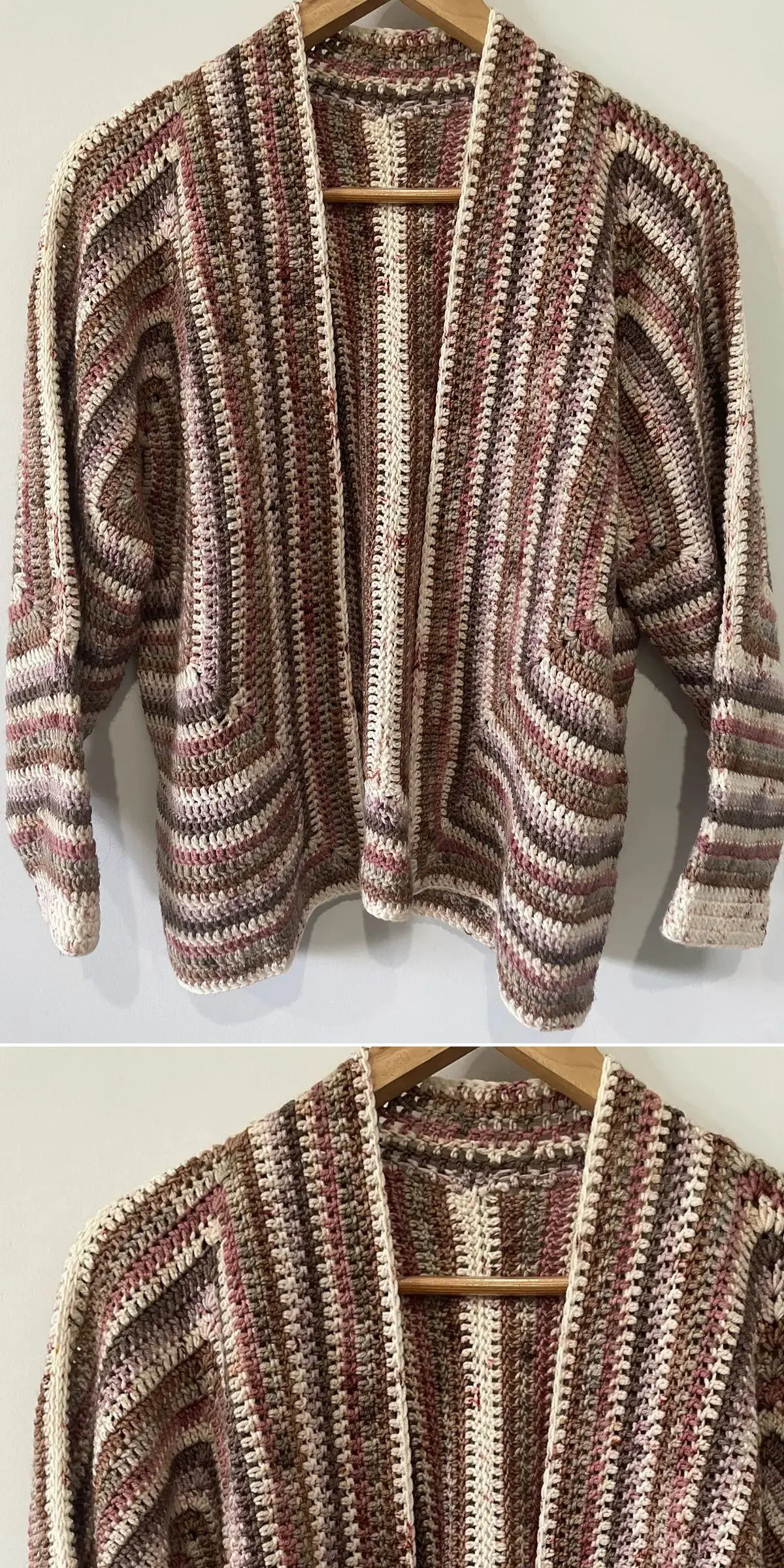A handmade, multicolored crochet granny square cardigan with a geometric pattern hangs on a wooden hanger.