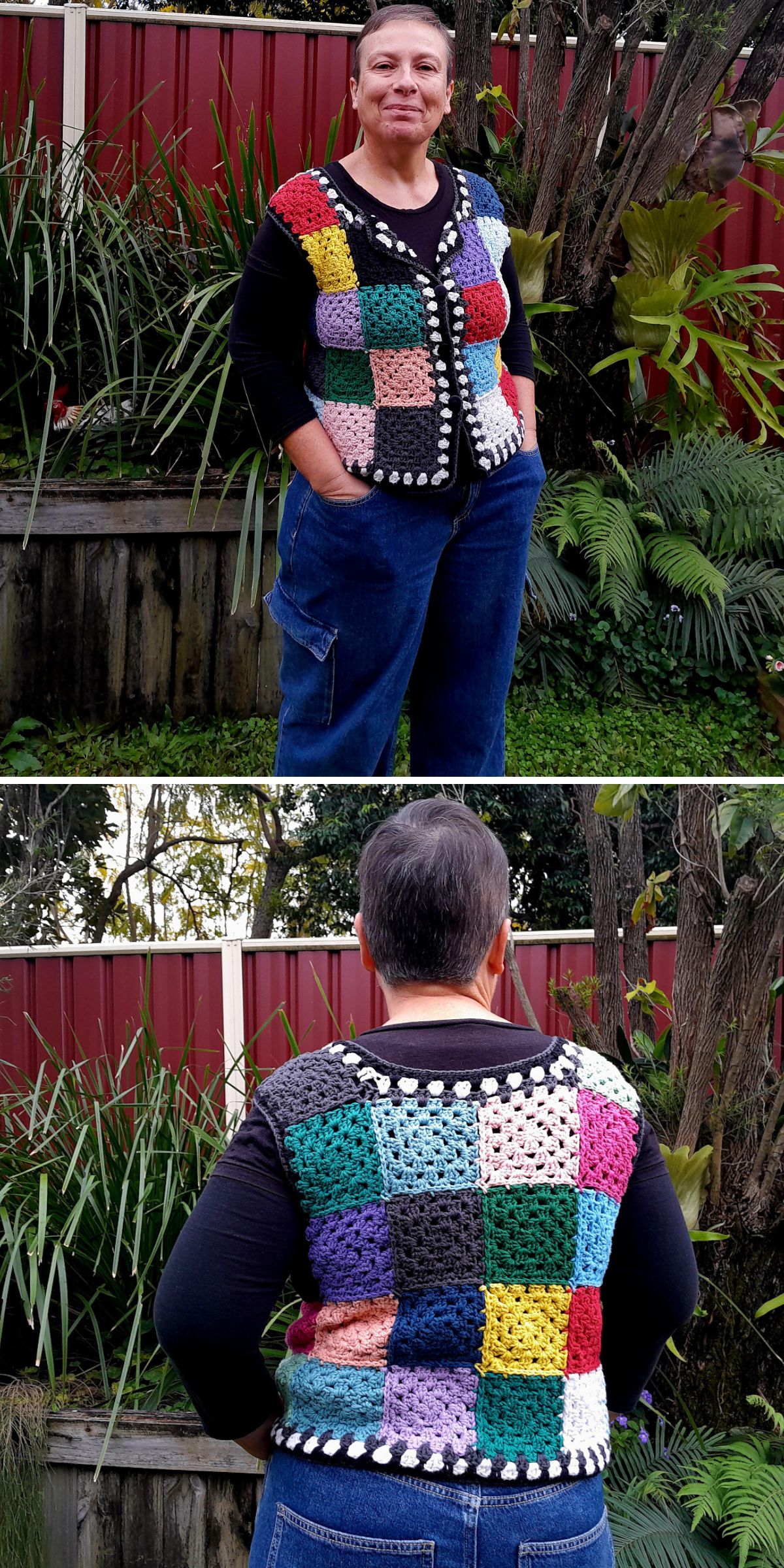A person stands outdoors in a crochet vest with multicolored patchwork squares, black trim, and white bobble details, layered over a black shirt and blue jeans.