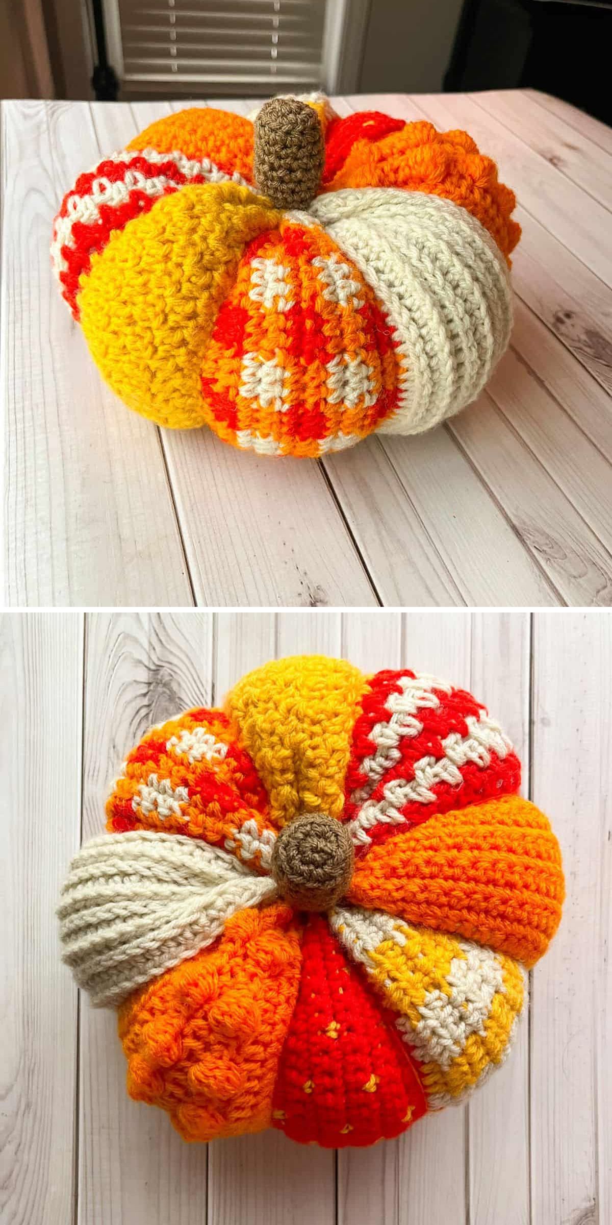 A crochet pumpkin with segments in various patterns and shades of orange, yellow, white, and red sits on a light wooden surface.