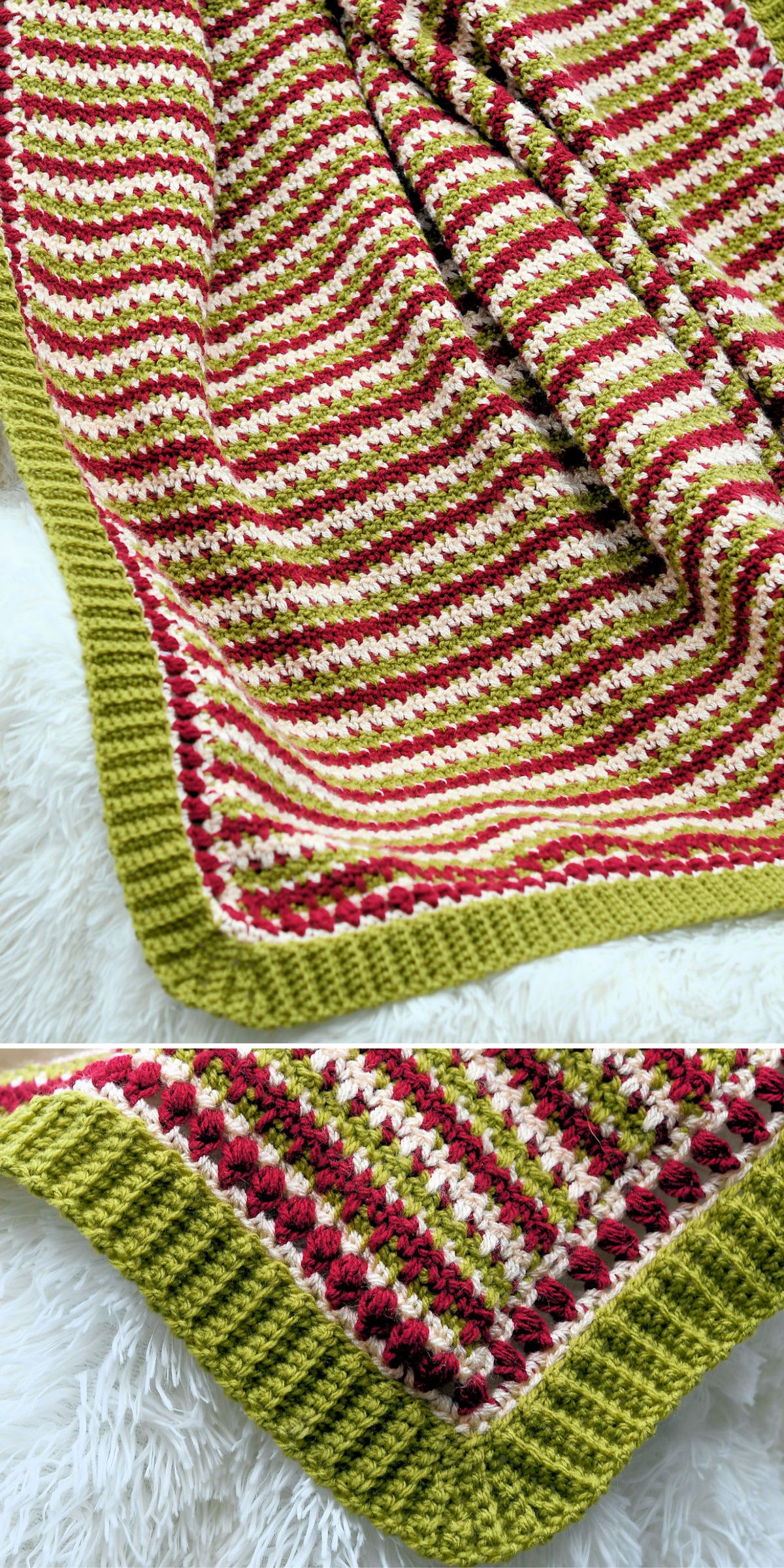 A crocheted Christmas crochet blanket with red, green, cream, and pink stripes, finished with a textured green border, is shown laid out on a white fluffy surface.