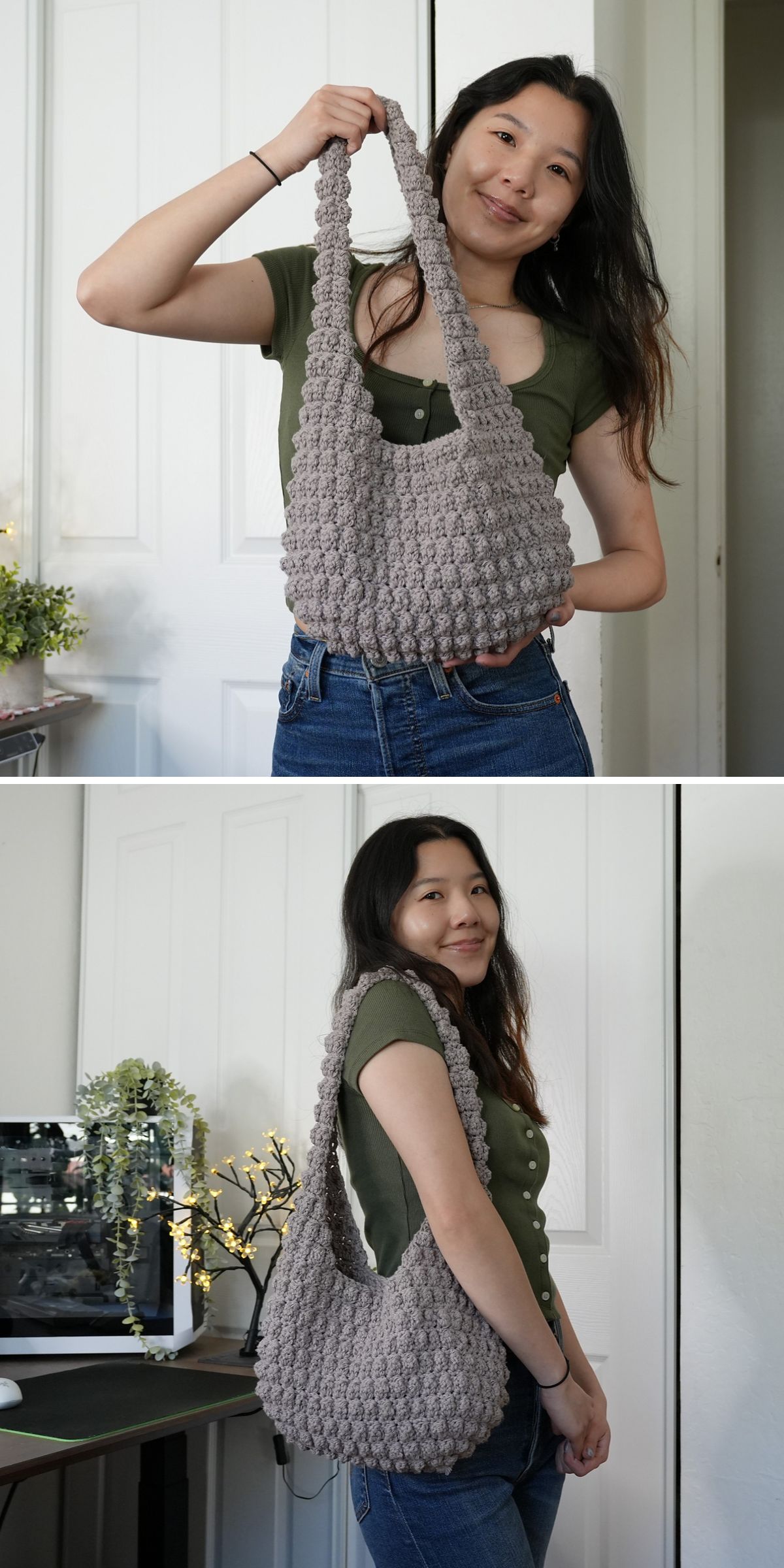 A woman holds and models a gray crocheted handbag in front of a white door, wearing a green top and blue jeans.