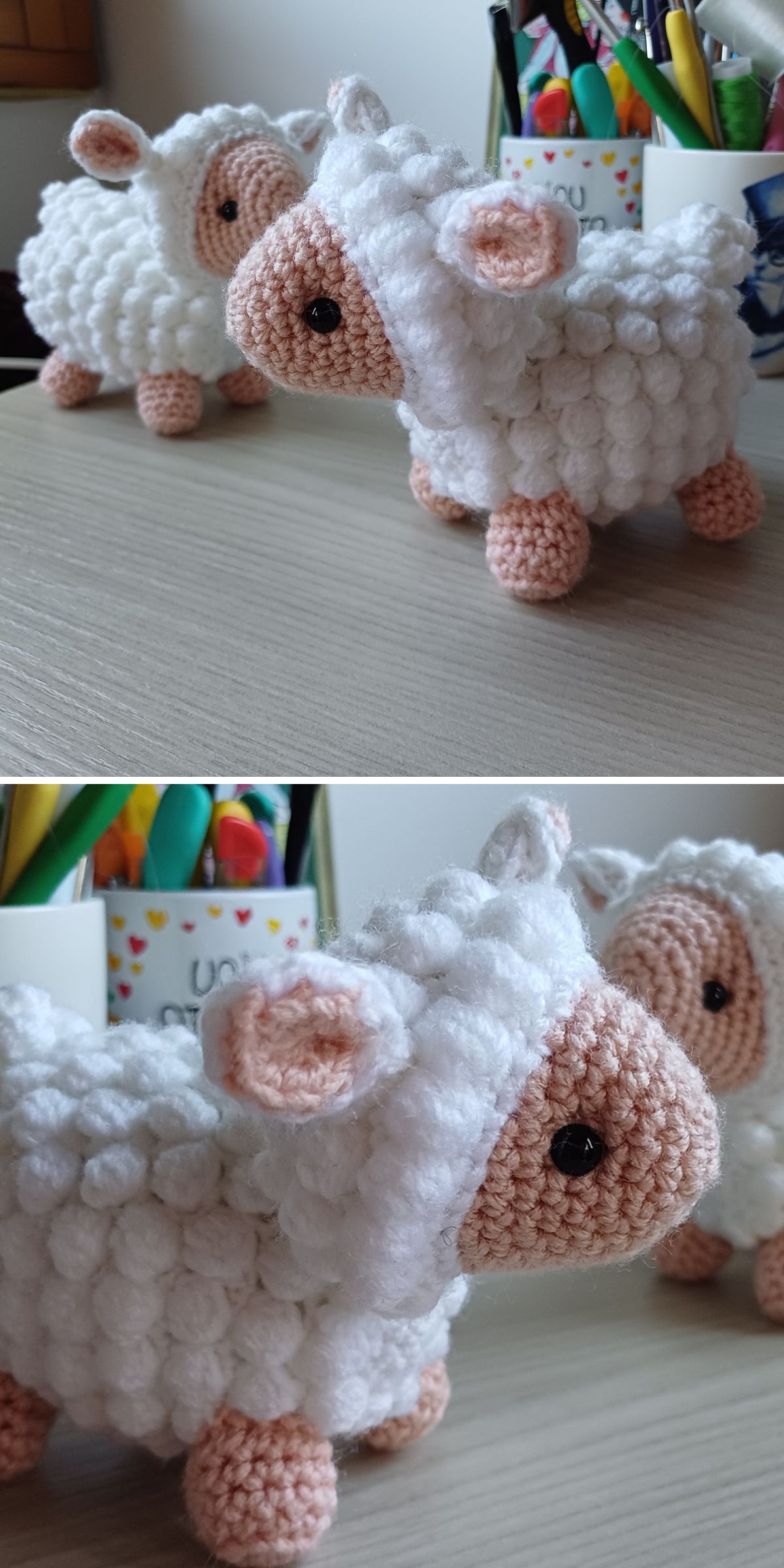 Two crocheted sheep made with white and beige yarn are displayed on a desk, joined by a crochet llama, with stationery and colorful pens in the background.