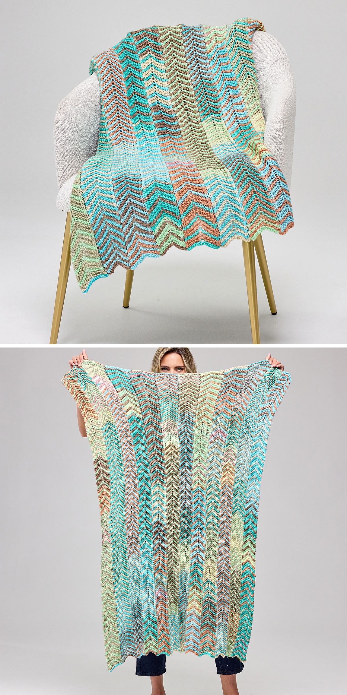 A knitted blanket with a multicolored zigzag pattern draped over a white chair and held up by a person, showing its full size.