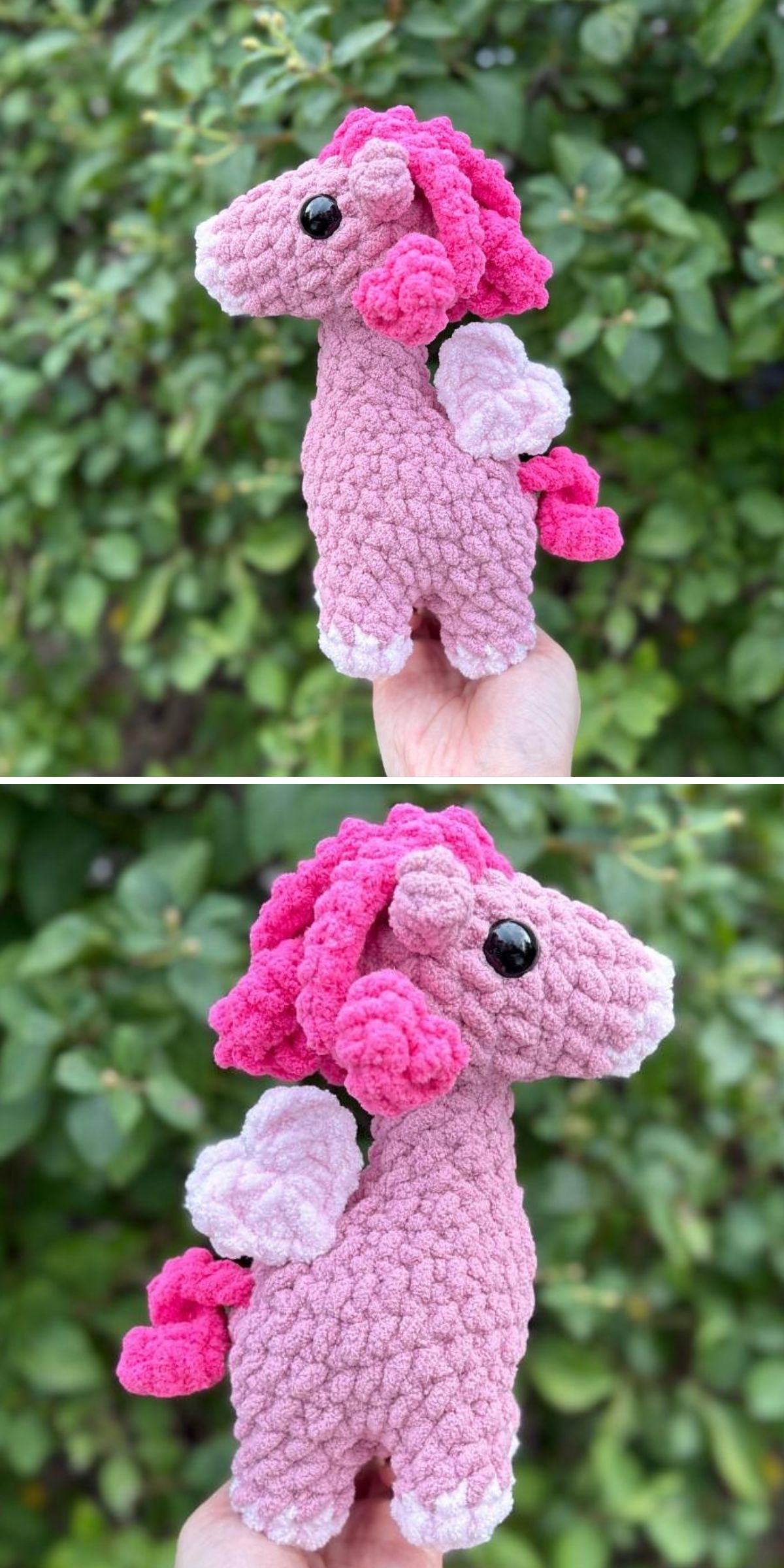 A hand holds a crochet horse amigurumi designed as a pink unicorn plush with white wings and a curly mane, shown from the side against a leafy green background.