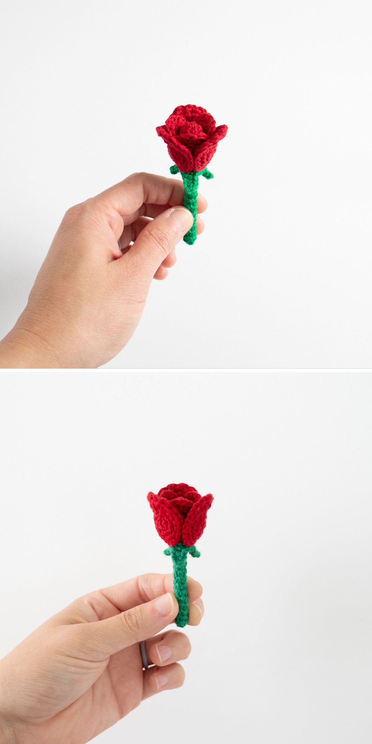 Two hands holding a small red rose with a green stem, crafted using a crochet flower pattern, against a plain white background.