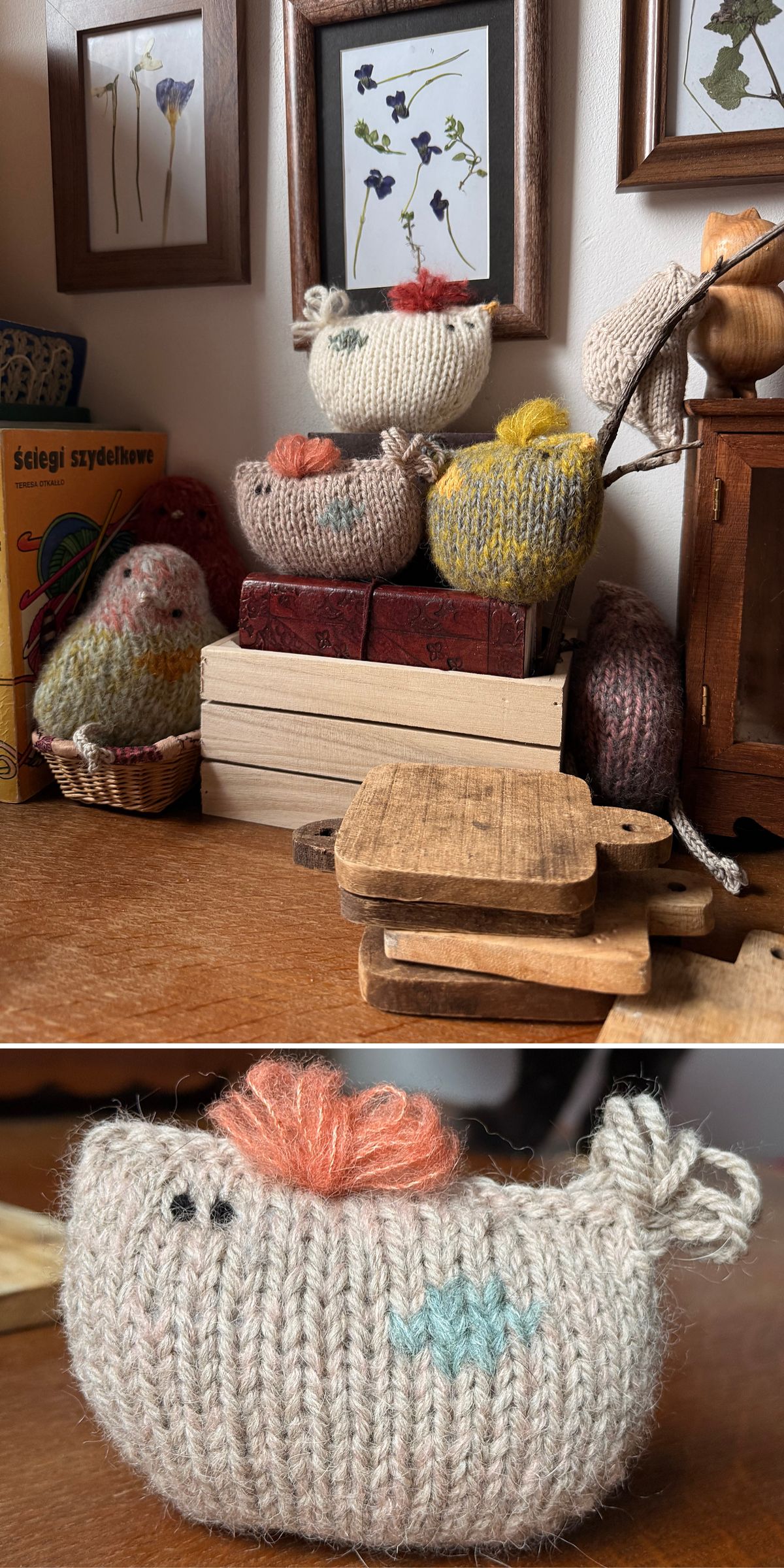 A collection of knitted chicken toys sits on a wooden surface with small cutting boards, books, and framed pressed flowers in the background — perfectly complementing charming knitted Easter decorations. Close-up shows details of one chicken’s stitching.