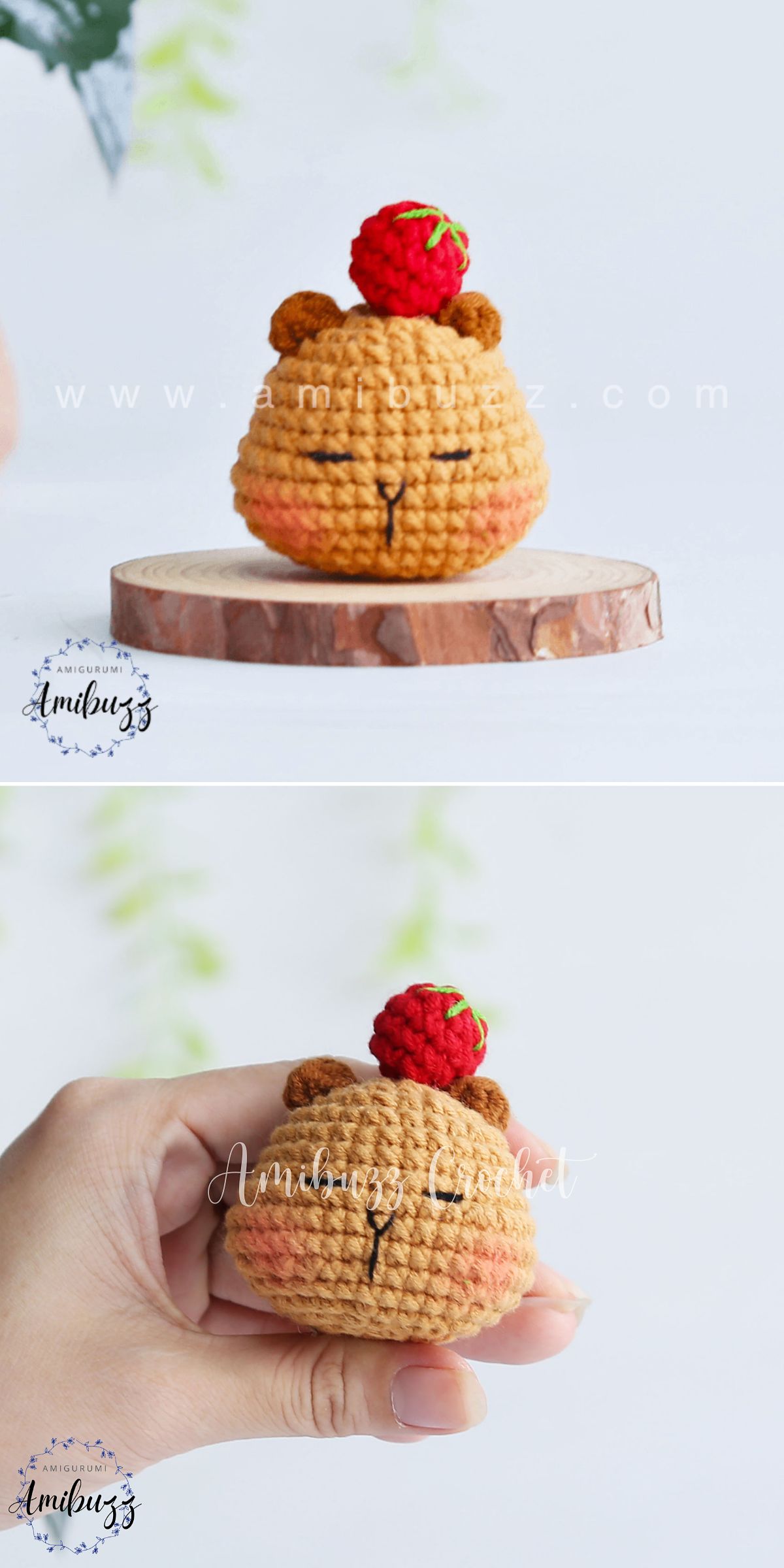A small crocheted capybara with a red raspberry on its head is displayed on a wooden base and held in a hand, accompanied by a charming crochet capybara for added cuteness.