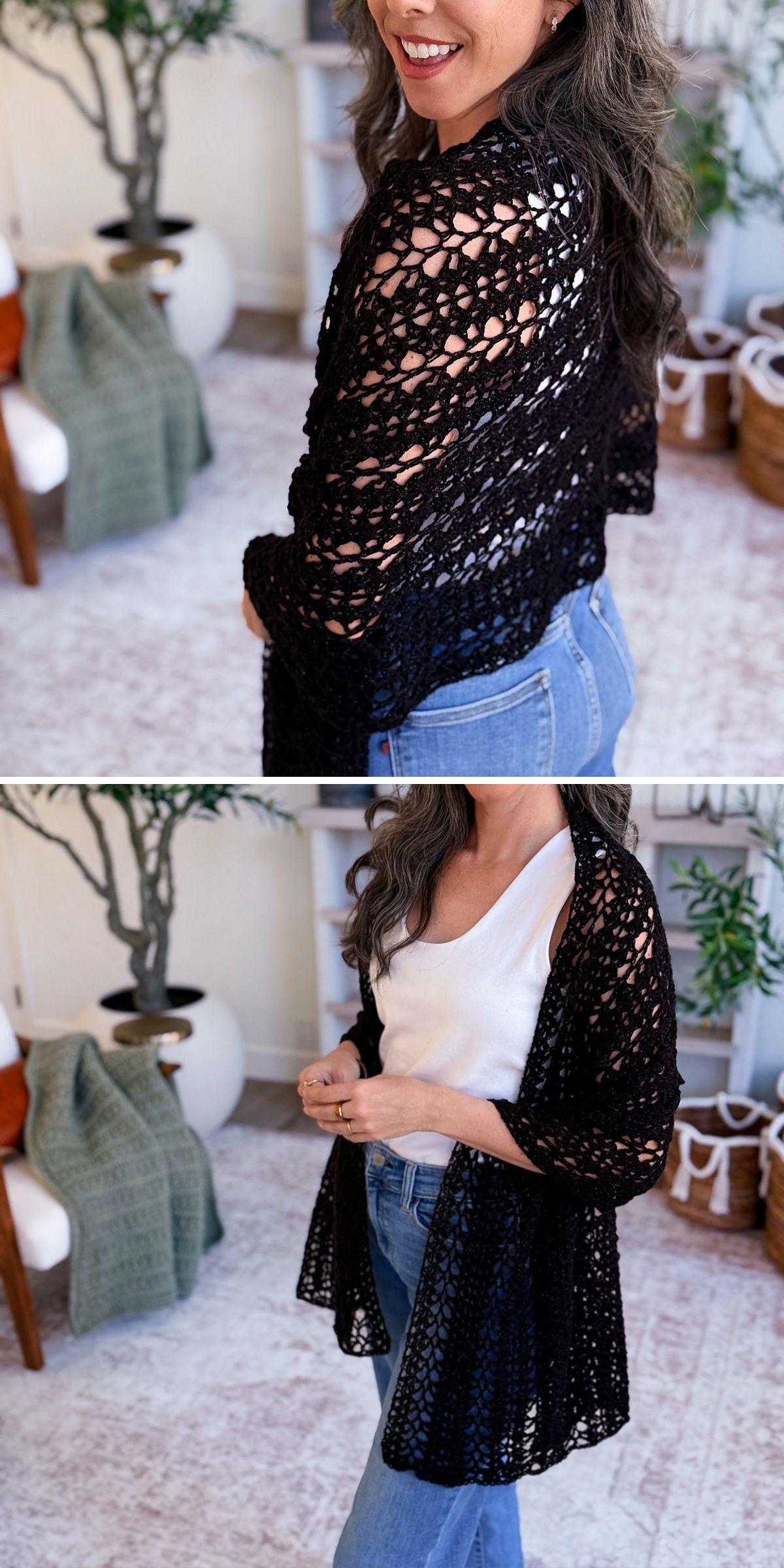 A woman models a black, open-knit crochet wrap cardigan over a white top and blue jeans in a cozy indoor setting with plants and a green blanket on a chair.
