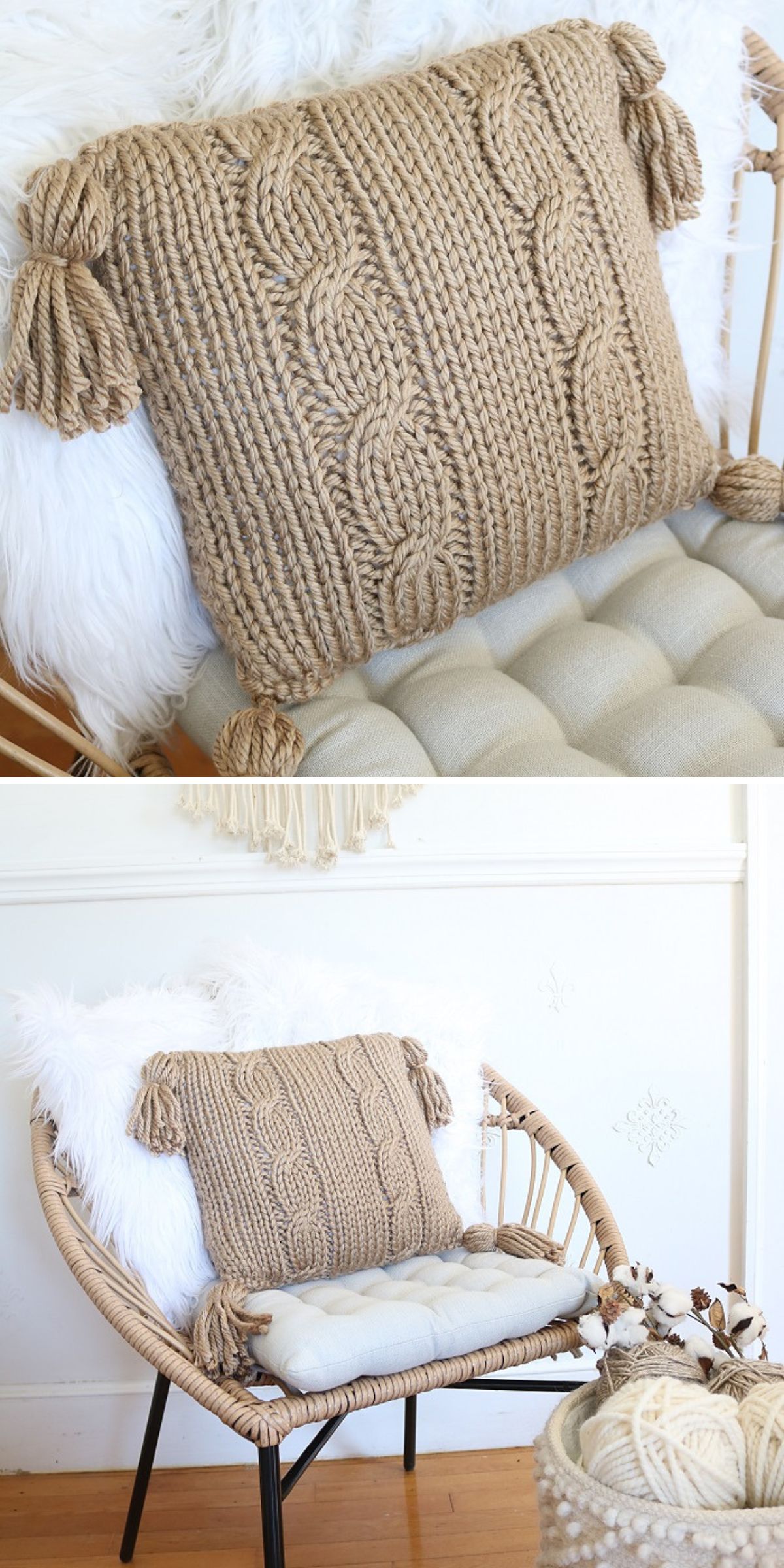 A chunky knit pillow with tassels on each corner sits on a cushioned chair, paired with a white fluffy throw in a light, cozy room.