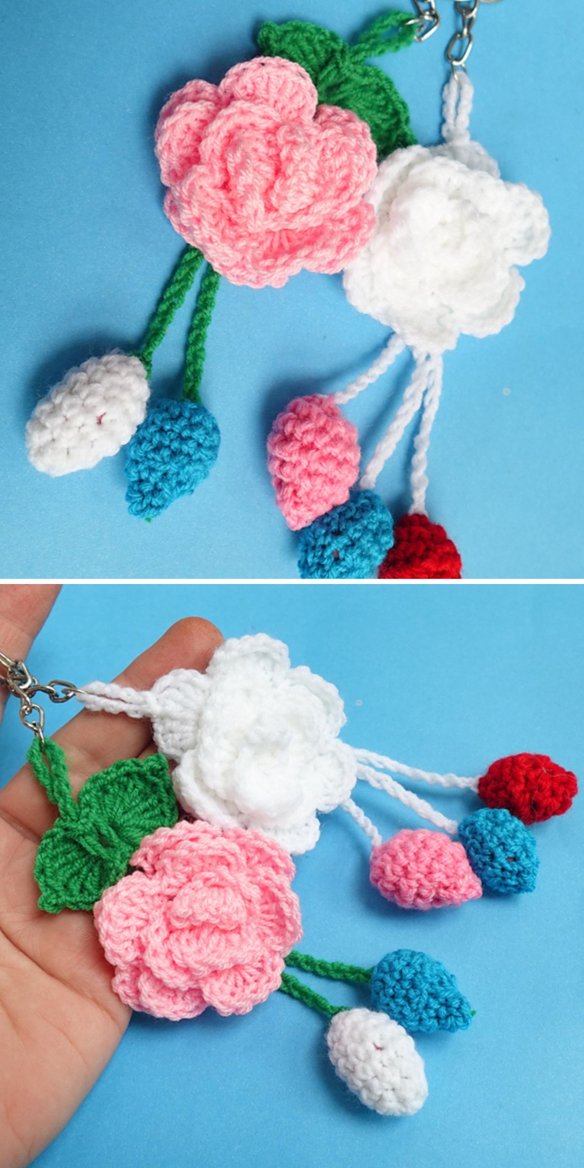 Two crochet keychain flowers with pink and white roses, green leaves, and blue, pink, and red buds are held against a blue background.
