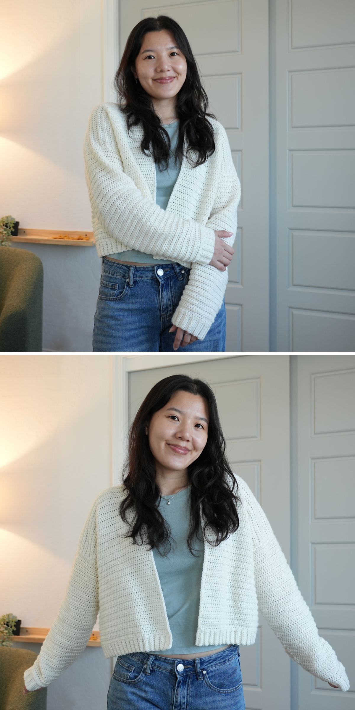 A woman with long dark hair wears a cream crochet cardigan over a light blue shirt and jeans, standing indoors in front of a door.
