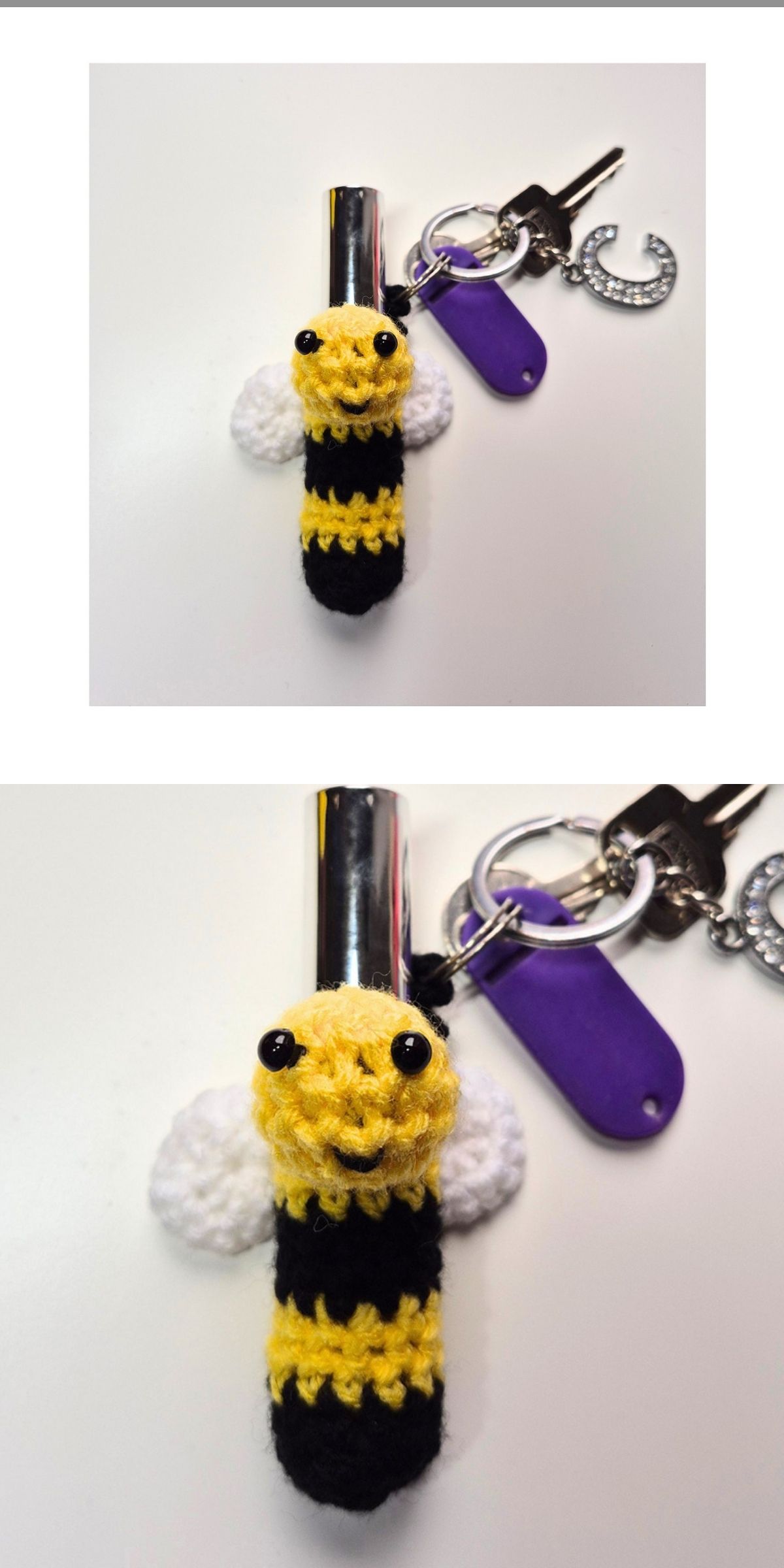 A crochet bee keychain with white wings, black and yellow stripes, and black eyes is attached to a keyring with keys and a purple tag.