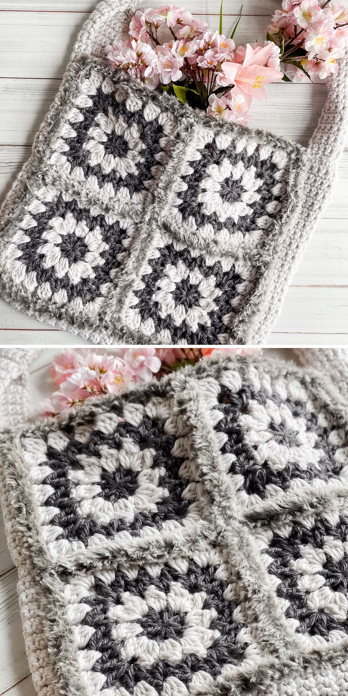 A crocheted tote bag made of four gray and white granny squares, with a textured handle and pink flowers placed inside, displayed on a white wooden background.