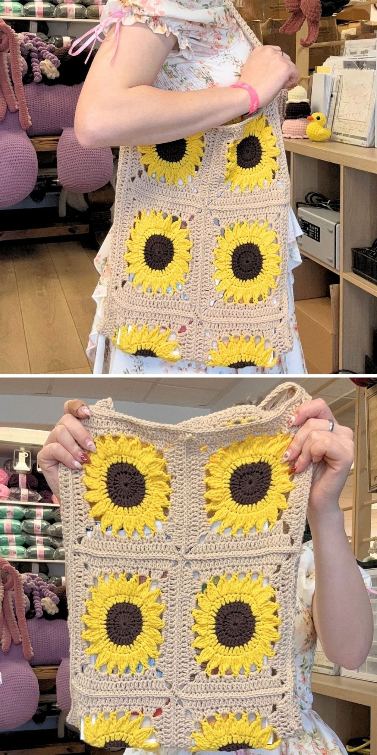 A person holding a handmade granny square bag with sunflower motifs on a beige background.