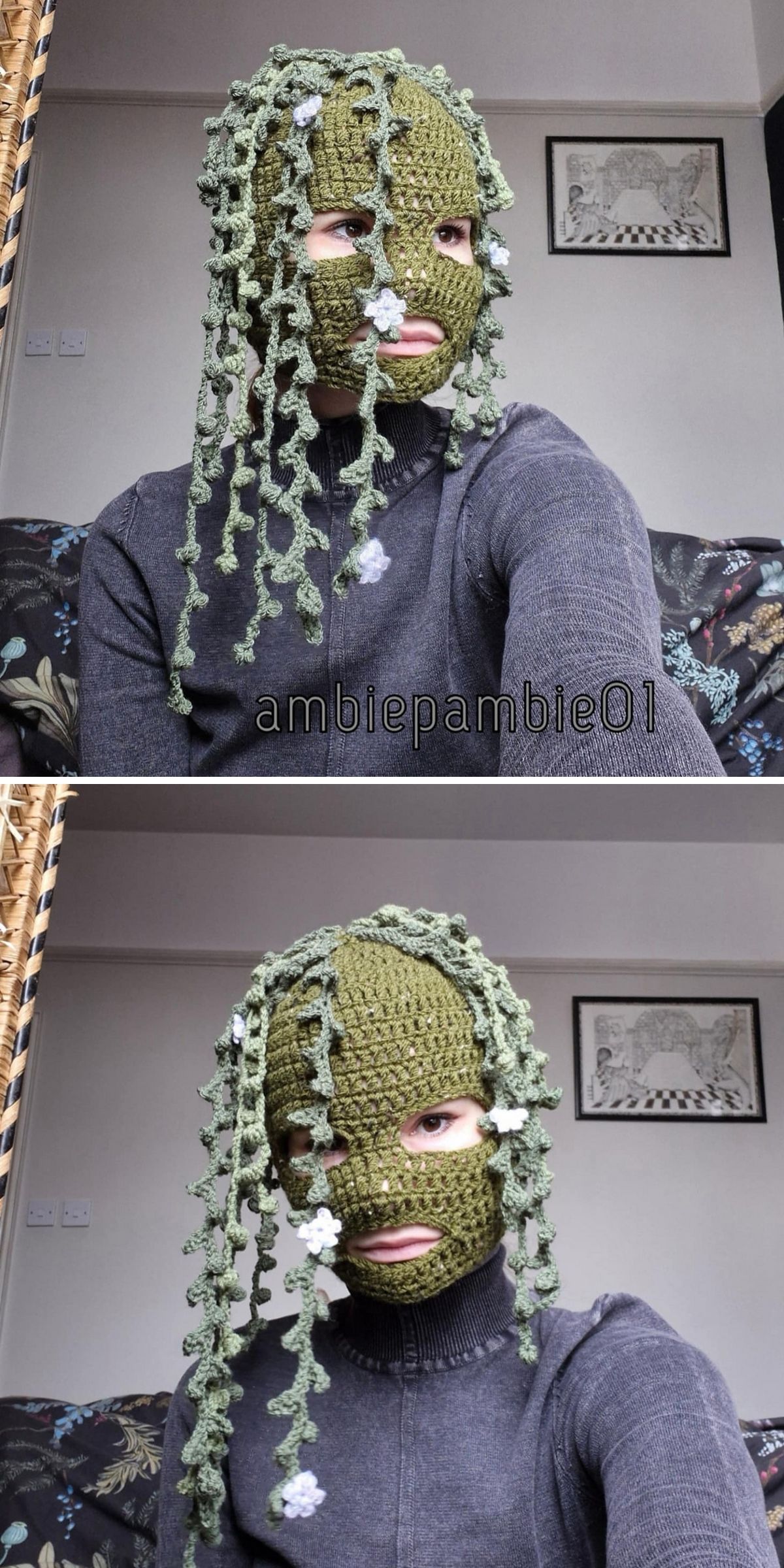 A person wears a green funny crochet hat styled like a balaclava, adorned with vine and flower details, while sitting on a patterned couch with framed art visible on the wall behind them.